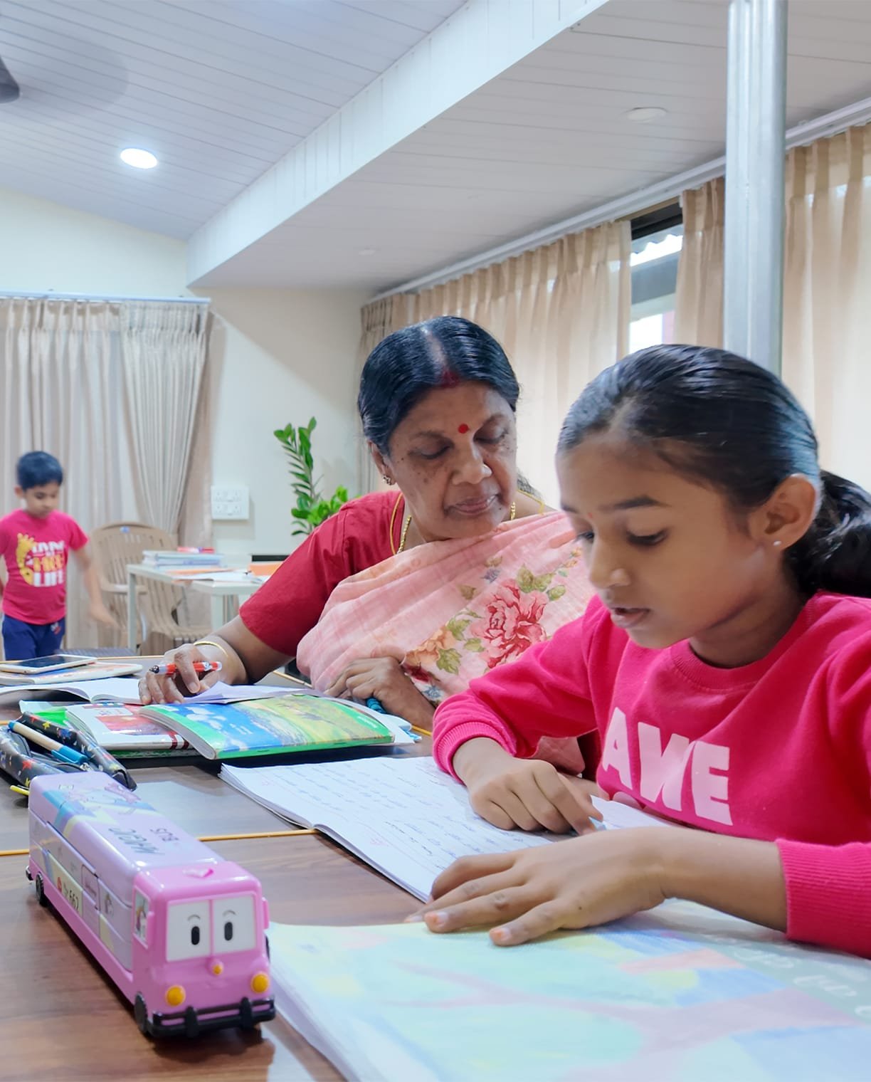 Experienced faculty mentor guiding a student in a classroom discussion.