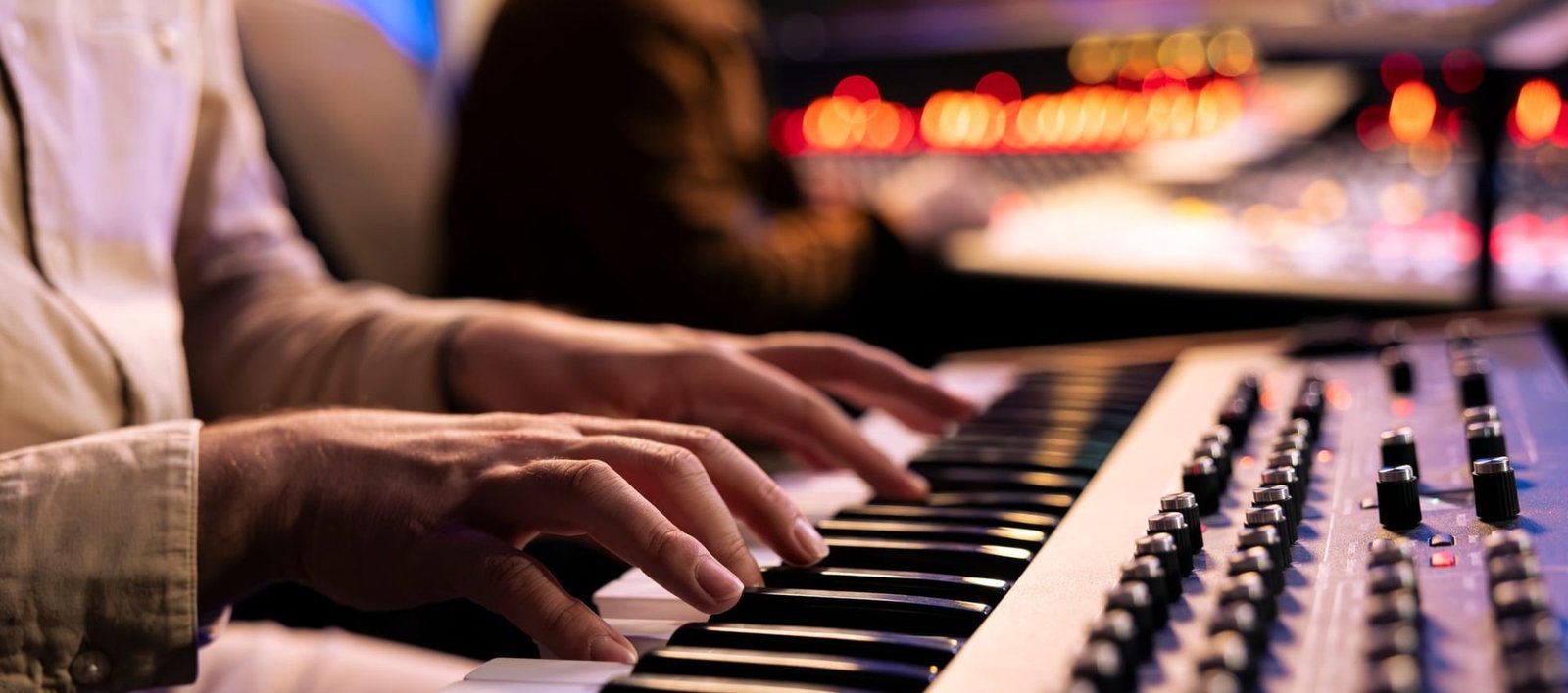 Artist performer recording his song on electronic keyboard piano
